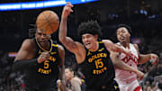 Jan 13, 2025; Toronto, Ontario, CAN; Golden State Warriors forward Kevon Looney (5) and forward Gui Santos (15) go after a loose ball against the Toronto Raptors during the first half at Scotiabank Arena. Mandatory Credit: John E. Sokolowski-Imagn Images