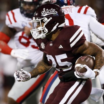 Nov 23, 2023; Starkville, Mississippi, USA; Mississippi State Bulldogs running back Jeffery Pittman (25) runs the ball during the first half against the Mississippi Rebels at Davis Wade Stadium at Scott Field. Mandatory Credit: Petre Thomas-USA TODAY Sports