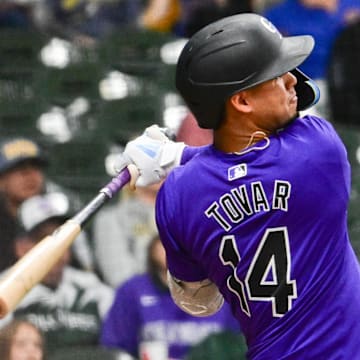 Sep 6, 2024; Milwaukee, Wisconsin, USA;  Colorado Rockies shortstop Ezequiel Tovar (14) hits a double in the sixth inning against the Milwaukee Brewers at American Family Field.