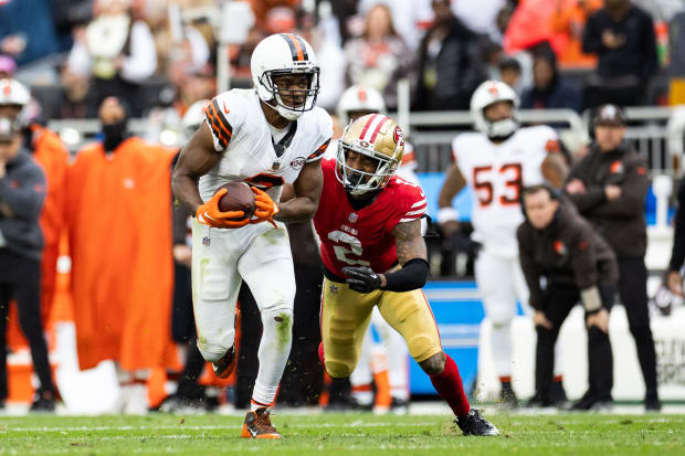 Wide receiver runs with football.