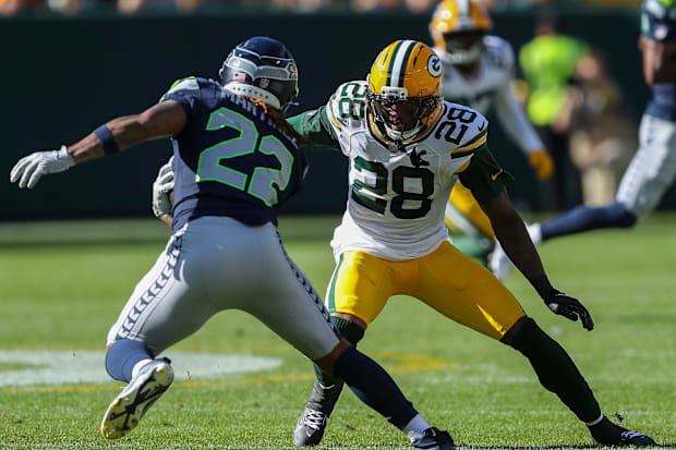 Green Bay Packers linebacker Isaiah Simmons (28) tackles Seattle Seahawks running back Damien Martinez.