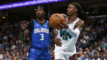 Oct 26, 2024; Memphis, Tennessee, USA; Memphis Grizzlies guard Ja Morant (12) passes the ball as Orlando Magic guard Kentavious Caldwell-Pope (3) defends during the second half at FedExForum. Mandatory Credit: Petre Thomas-Imagn Images