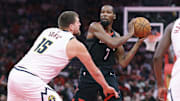 Nov 21, 2025; Houston, Texas, USA; Houston Rockets forward Kevin Durant (7) looks to pass the ball as Denver Nuggets center Nikola Jokic (15) defends during the second quarter at Toyota Center. Mandatory Credit: Troy Taormina-Imagn Images