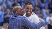 Mar 5, 2024; Chapel Hill, North Carolina, USA; North Carolina Tar Heels head coach Hubert Davis hugs forward Armando Bacot (5) on his last home game during the second half against the Notre Dame Fighting Irish at Dean E. Smith Center. Mandatory Credit: Jim Dedmon-Imagn Images