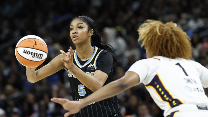 Jun 23, 2024; Chicago, Illinois, USA; Chicago Sky forward Angel Reese (5) passes the ball against Indiana Fever forward NaLyssa Smith (1) during the second half of a basketball game at Wintrust Arena. 