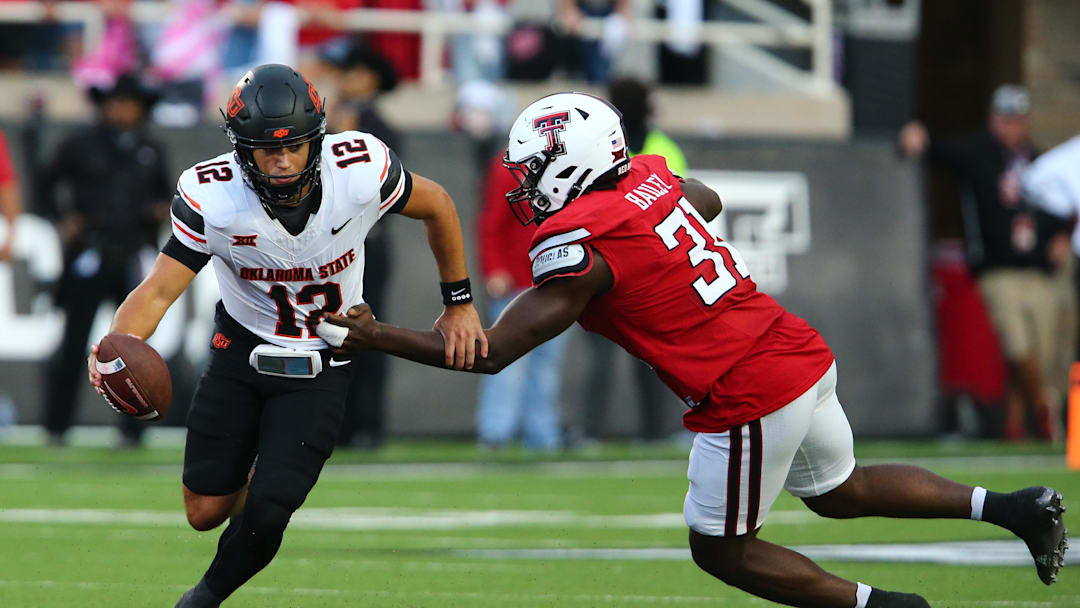 Oct 25, 2025; Lubbock, Texas, USA;  Texas Tech Red Raiders defensive end David Bailey (31) pressures Oklahoma State Cowboys quarterback Noah Walters (12) in the second half at Jones AT&T Stadium. Mandatory Credit: Michael C. Johnson-Imagn Images