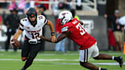 Oct 25, 2025; Lubbock, Texas, USA;  Texas Tech Red Raiders defensive end David Bailey (31) pressures Oklahoma State Cowboys quarterback Noah Walters (12) in the second half at Jones AT&T Stadium. Mandatory Credit: Michael C. Johnson-Imagn Images