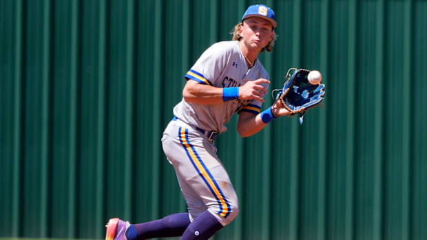 Colorado Rockies prospect Ethan Holliday fields a ground ball in his high school uniform. 