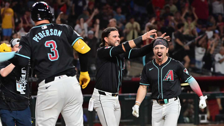 Jul 29, 2024; Phoenix, Arizona, USA;  Arizona Diamondbacks outfielder Corbin Carroll (7) celebrates with teammates after hitting a walk off home run in the ninth inning to beat the Washington Nationals at Chase Field. Mandatory Credit: Matt Kartozian-USA TODAY Sports