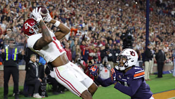 Nov 25, 2023; Auburn, Alabama, USA;  Alabama Crimson Tide wide receiver Isaiah Bond (17) scores the game winning touchdown over Auburn Tigers cornerback D.J. James (4) during the fourth quarter at Jordan-Hare Stadium. Mandatory Credit: John Reed-USA TODAY Sports