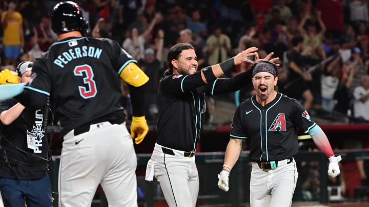 Jul 29, 2024; Phoenix, Arizona, USA;  Arizona Diamondbacks outfielder Corbin Carroll (7) celebrates with teammates after hitting a walk off home run in the ninth inning to beat the Washington Nationals at Chase Field. Mandatory Credit: Matt Kartozian-USA TODAY Sports