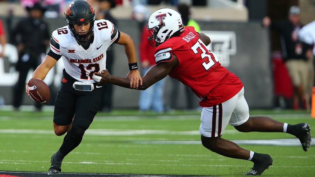 Texas Tech Red Raiders defensive end David Bailey pressures Oklahoma State Cowboys quarterback Noah Walters.