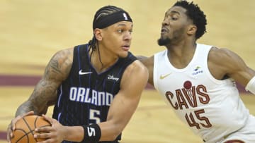 Orlando Magic forward Paolo Banchero (5) looks to pass beside Cleveland Cavaliers guard Donovan Mitchell (45) in the first quarter during game two of the first round of the 2024 NBA playoffs at Rocket Mortgage FieldHouse. 