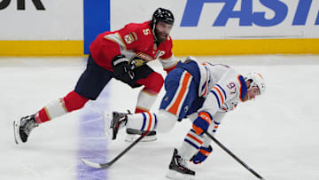 Aaron Ekblad battles Connor McDavid for the puck during the 2025 Stanley Cup Final.