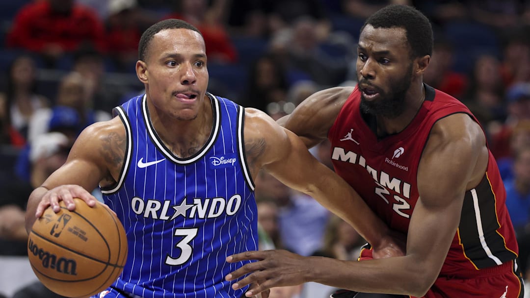 Dec 5, 2025; Orlando, Florida, USA; Orlando Magic guard Desmond Bane (3) drives to the basket past Miami Heat forward Andrew Wiggins (22) in the fourth quarter  at Kia Center. Mandatory Credit: Nathan Ray Seebeck-Imagn Images