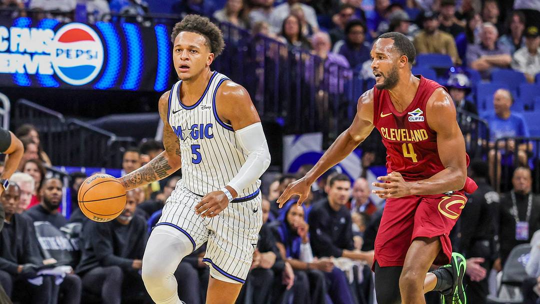 Oct 13, 2026; Orlando, Florida, USA;  Orlando Magic forward Paolo Banchero (5) brings the ball up court against Cleveland Cavaliers forward Evan Mobley (4) during the first quarter at Kia Center.  Mandatory Credit: Mike Watters-Imagn Images