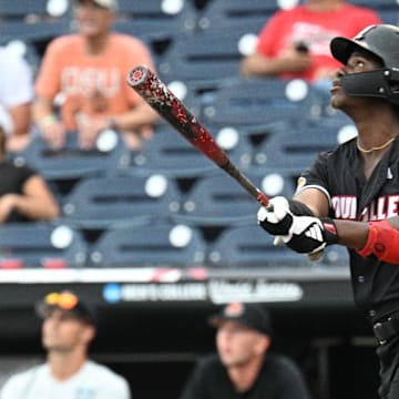 Jun 17, 2025; Omaha, Neb, USA;  Louisville Cardinals right fielder Eddie King Jr. (42) hits a sacrifice file to drive in the winning run against the Oregon State Beavers during the ninth inning at Charles Schwab Field. Mandatory Credit: Steven Branscombe-Imagn Images