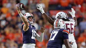 Aug 31, 2024; Auburn, Alabama, USA;  Auburn Tigers quarterback Hank Brown (15) throws a pass as Alabama A&M Bulldogs defensive lineman Kevin Herring (56) closes in during the fourth quarter at Jordan-Hare Stadium.  Mandatory Credit: John Reed-Imagn Images