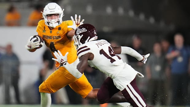 Arizona State running back Cam Skattebo (4) stiff arms his way past Mississippi State Bulldogs cornerback Brice Pollock