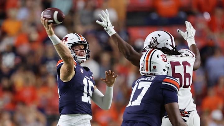 Aug 31, 2024; Auburn, Alabama, USA;  Auburn Tigers quarterback Hank Brown (15) throws a pass as Alabama A&M Bulldogs defensive lineman Kevin Herring (56) closes in during the fourth quarter at Jordan-Hare Stadium.  Mandatory Credit: John Reed-Imagn Images