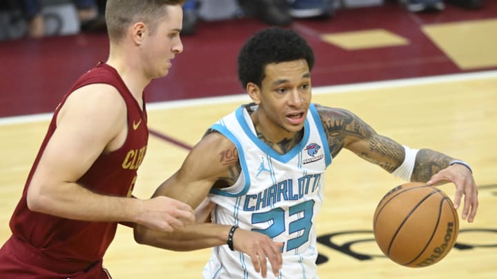 Mar 25, 2024; Cleveland, Ohio, USA; Cleveland Cavaliers guard Sam Merrill (5) defends Charlotte Hornets guard Tre Mann (23) in the third quarter at Rocket Mortgage FieldHouse. Mandatory Credit: David Richard-USA TODAY Sports