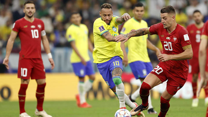 Neymar battles for the ball with Sergej Milinkovic-Savic during the 2022 FIFA World Cup in Qatar