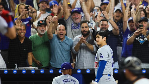 Dodgers designated hitter Shohei Ohtani reacts to a standing ovation in Miami.