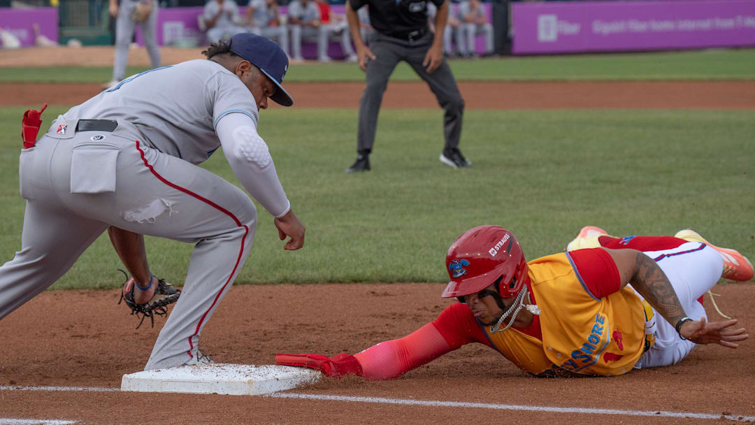 Blue Claws Eduardo Tait dives back to first as the Blue Rocks’ Roismar Quintana is late with the tag. Wilmington Blue Rocks have a rough outing against Jersey Shore BlueClaws in Lakewood NJ on July 27, 2025.