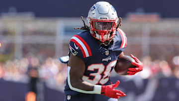 Oct 6, 2024; Foxborough, Massachusetts, USA; New England Patriots running back Rhamondre Stevenson (38) runs the ball during the first half against the Miami Dolphins at Gillette Stadium. Mandatory Credit: Paul Rutherford-Imagn Images