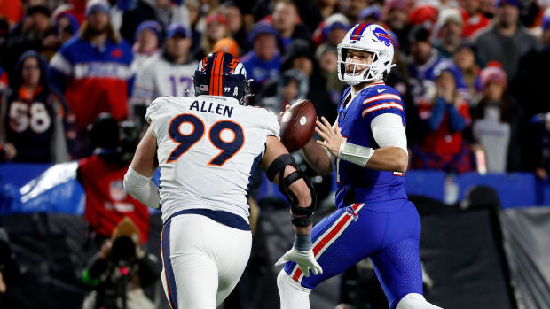 Denver Broncos defensive end Zach Allen pursues Buffalo Bills quarterback Josh Allen. 