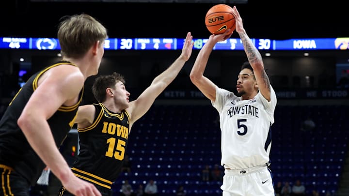 Feb 28, 2026; University Park, Pennsylvania, USA; Penn State Nittany Lions guard Freddie Dilione V (5) attempts a three-point shot as Iowa Hawkeyes guard Brendan Hausen (15) defends during the first half at Bryce Jordan Center. Mandatory Credit: Matthew O'Haren-Imagn Images