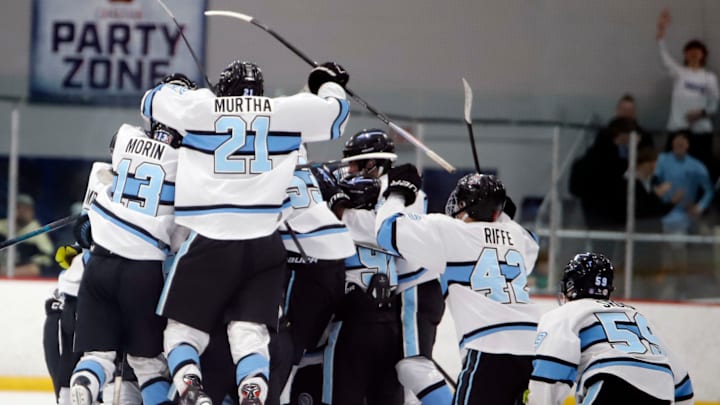The Seneca Valley hockey team swarms defenseman Carter Hoehn after he scored the overtime game winner Monday at the RMU Island Sports Center