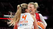 Indiana Fever guard Sophie Cunningham collides with Connecticut Sun guard Jacy Sheldon.