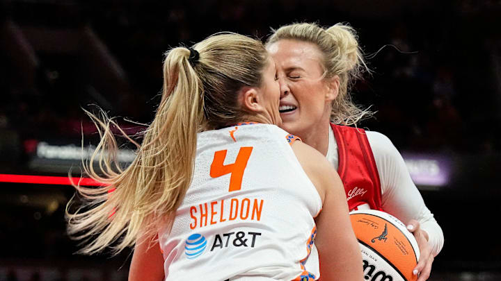 Indiana Fever guard Sophie Cunningham collides with Connecticut Sun guard Jacy Sheldon. Indiana Fever guard Sophie Cunningham collides with Connecticut Sun guard Jacy Sheldon.