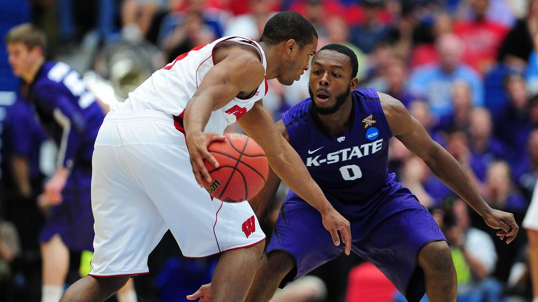 Mar 19, 2011; Tucson, AZ, USA; Kansas State Wildcats guard Jacob Pullen (0) guards the Wisconsin Badgers guard Jordan Taylor (11) during the third round of the 2011 NCAA men's basketball tournament at the McKale Center. The Badgers defeated the Wildcats 70-65. 