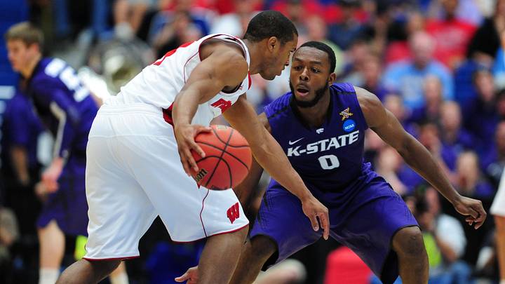 Mar 19, 2011; Tucson, AZ, USA; Kansas State Wildcats guard Jacob Pullen (0) guards the Wisconsin Badgers guard Jordan Taylor (11) during the third round of the 2011 NCAA men's basketball tournament at the McKale Center. The Badgers defeated the Wildcats 70-65. 