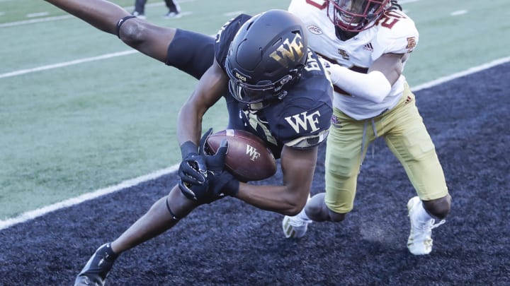 Oct 22, 2022; Winston-Salem, North Carolina, USA;  Wake Forest Demon Deacons wide receiver Jahmal Banks catches a touchdown pass as Boston College Eagles defensive back Elijah Jones defends.