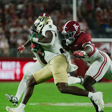 Sep 7, 2024; Tuscaloosa, Alabama, USA;  Alabama Crimson Tide linebacker Justin Jefferson (15) dives for South Florida Bulls running back Ta'Ron Keith (9) as he runs the ball down the field during the fourth quarter at Bryant-Denny Stadium. Mandatory Credit: William McLelland-Imagn Images