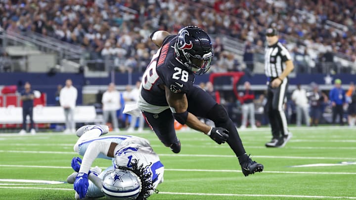 Nov 18, 2024; Arlington, Texas, USA; Houston Texans running back Joe Mixon (28) dives for yardage past Dallas Cowboys cornerback Trevon Diggs (7) during the second half at AT&T Stadium. Mandatory Credit: Kevin Jairaj-Imagn Images Nov 18, 2024; Arlington, Texas, USA; Houston Texans running back Joe Mixon (28) dives for yardage past Dallas Cowboys cornerback Trevon Diggs (7) during the second half at AT&T Stadium. Mandatory Credit: Kevin Jairaj-Imagn Images