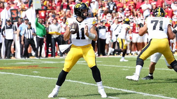 Sep 6, 2025; Ames, Iowa, USA; Iowa Hawkeyes quarterback Mark Gronowski (11) looks to pass the ball against the Iowa State Cyclones during the first quarter at Jack Trice Stadium. Mandatory Credit: Reese Strickland-Imagn Images