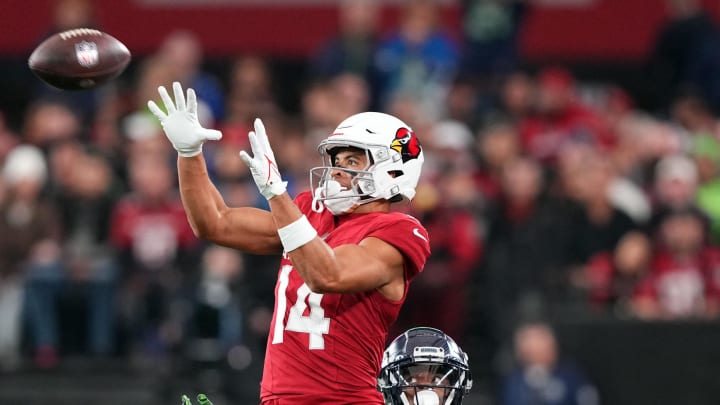 Jan 7, 2024; Glendale, Arizona, USA; Arizona Cardinals wide receiver Michael Wilson (14) catches a pass against Seattle Seahawks cornerback Tre Brown (22) during the second half at State Farm Stadium. Mandatory Credit: Joe Camporeale-USA TODAY Sports