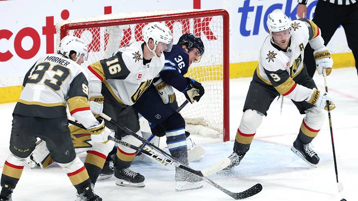 Mar 24, 2026; Winnipeg, Manitoba, CAN; Vegas Golden Knights center Jack Eichel (9) clears the puck away from Winnipeg Jets center Morgan Barron (36) in the third period at Canada Life Centre. Mandatory Credit: James Carey Lauder-Imagn Images