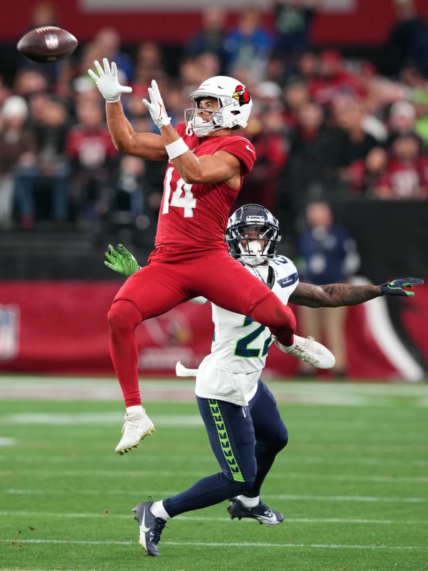 rizona Cardinals wide receiver Michael Wilson (14) catches a pass against Seattle Seahawks cornerback Tre Brown (22).