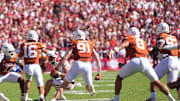 The Texas defensives converges on Oklahoma Sooners quarterback John Mateer (10) in the first half of the Red River Rivalry college football game between the University of Oklahoma Sooners and the Texas Longhorn at the Cotton Bowl Stadium in Dallas, Texas, Saturday, Oct. 11, 2025.