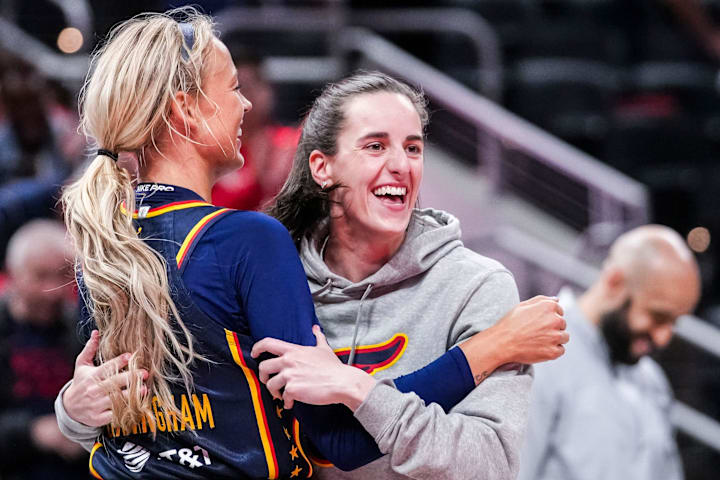 Indiana Fever Sophie Cunningham hugs Indiana Fever Caitlin Clark during a preseason game against the Washington Mystics.