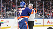 Jan 16, 2025; Elmont, New York, USA;  New York Islanders right wing Maxim Tsyplakov (7) and Philadelphia Flyers right wing Garnet Hathaway (19) fight in the first period at UBS Arena. Mandatory Credit: Wendell Cruz-Imagn Images