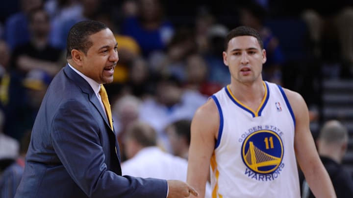 January 15, 2014; Oakland, CA, USA; Golden State Warriors head coach Mark Jackson (left) instructs in front of shooting guard Klay Thompson (11) against the Denver Nuggets during the first quarter at Oracle Arena. Mandatory Credit: Kyle Terada-Imagn Images