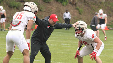 Defensive coordinator Mike Tressel works with linebackers Sebastian Cheeks (14) and Tyler Jansey (42) during the team's 10th spring practice, which was held on a practice field north of Camp Randall Stadium in Madison, Wisconsin on Saturday April 20, 2024.