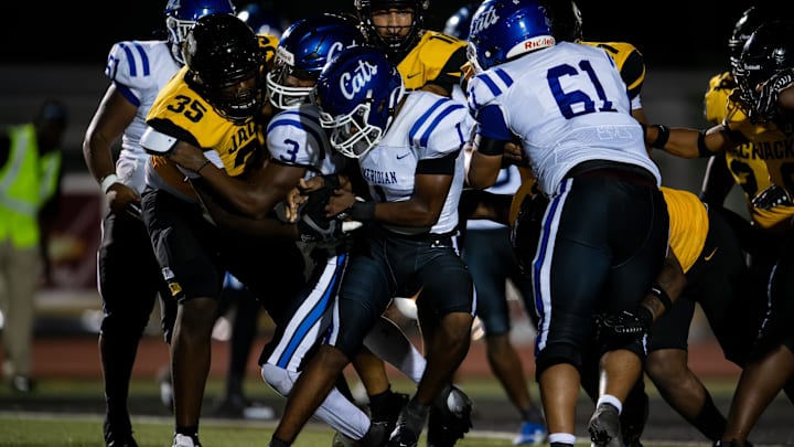 Meridian’s Martrevious Greer (1-1) runs into a host of Starkville Yellowjacket defenders on Friday, Sept. 13 in Starkville, Miss.