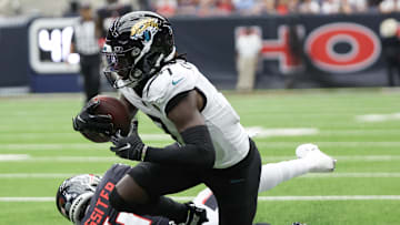 Sep 29, 2024; Houston, Texas, USA; Jacksonville Jaguars wide receiver Brian Thomas Jr. (7) is tackled by Houston Texans cornerback Kamari Lassiter (4) in the second half at NRG Stadium. Mandatory Credit: Thomas Shea-Imagn Images